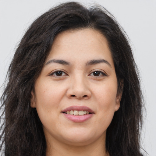 Joyful asian young-adult female with long  brown hair and brown eyes