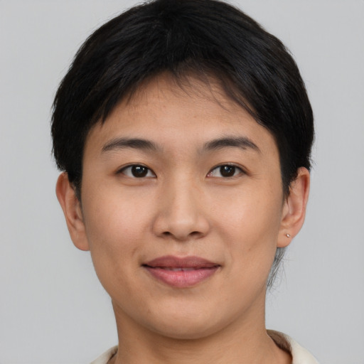 Joyful asian young-adult female with short  brown hair and brown eyes