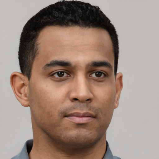 Neutral latino young-adult male with short  black hair and brown eyes