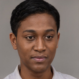 Joyful latino young-adult male with short  brown hair and brown eyes