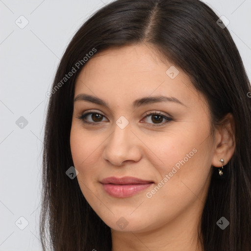 Joyful latino young-adult female with long  brown hair and brown eyes