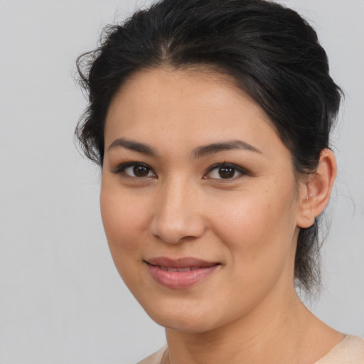 Joyful latino young-adult female with medium  brown hair and brown eyes
