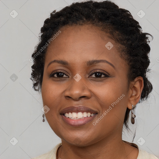 Joyful black young-adult female with long  brown hair and brown eyes