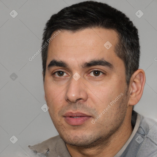 Joyful white young-adult male with short  black hair and brown eyes