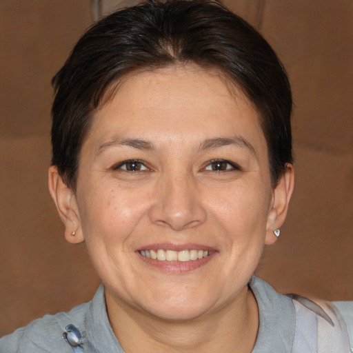 Joyful white adult female with medium  brown hair and brown eyes