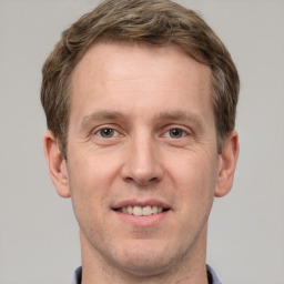 Joyful white adult male with short  brown hair and grey eyes