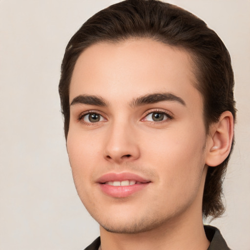 Joyful white young-adult male with medium  brown hair and brown eyes