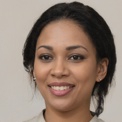 Joyful latino young-adult female with medium  black hair and brown eyes