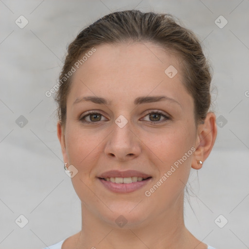 Joyful white young-adult female with short  brown hair and grey eyes