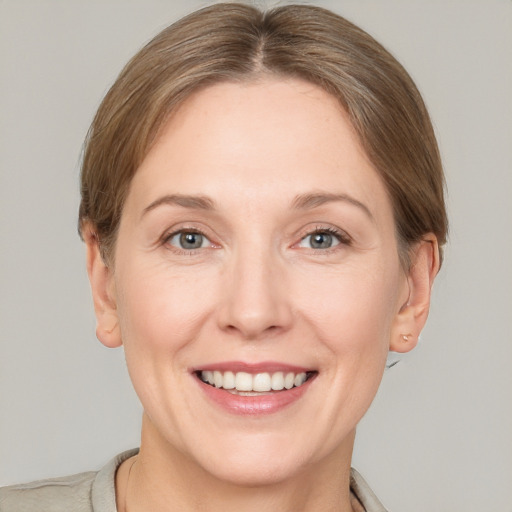 Joyful white adult female with short  brown hair and grey eyes