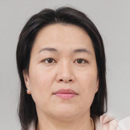 Joyful asian adult female with medium  brown hair and brown eyes