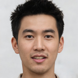 Joyful asian young-adult male with short  black hair and brown eyes