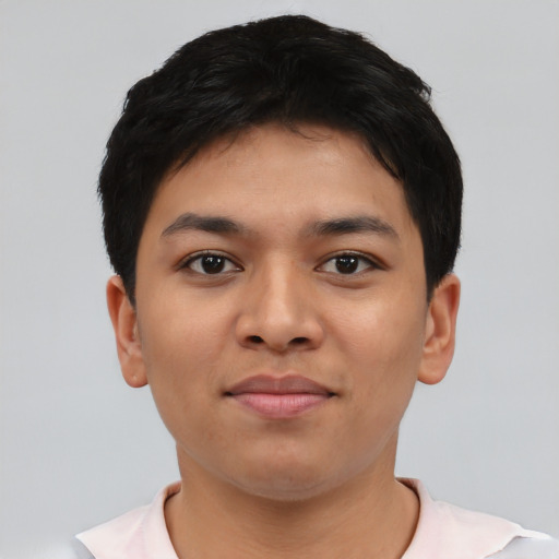 Joyful latino young-adult male with short  black hair and brown eyes