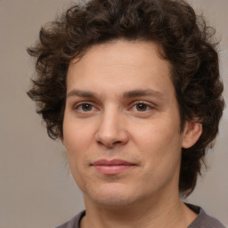 Joyful white young-adult male with medium  brown hair and brown eyes