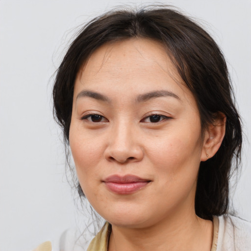 Joyful asian young-adult female with medium  brown hair and brown eyes