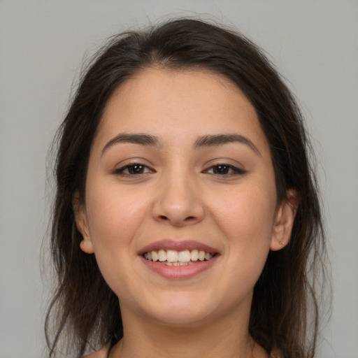 Joyful white young-adult female with medium  brown hair and brown eyes
