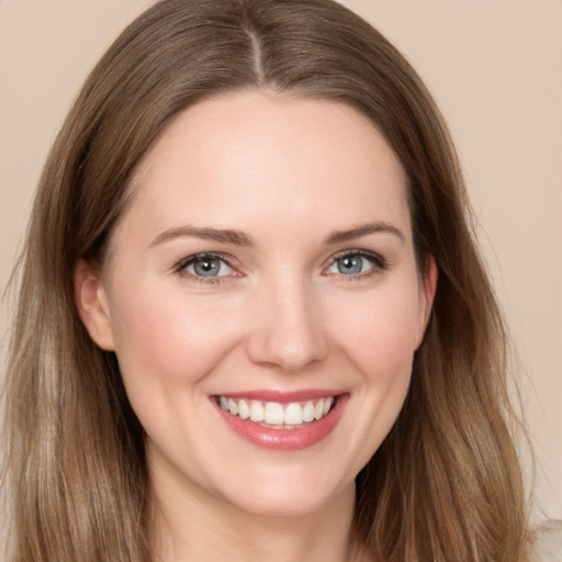 Joyful white young-adult female with long  brown hair and grey eyes