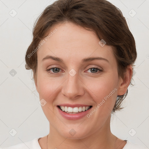 Joyful white young-adult female with short  brown hair and grey eyes