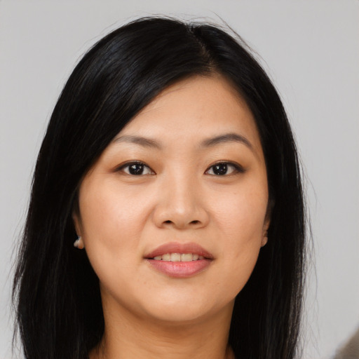 Joyful asian young-adult female with long  black hair and brown eyes