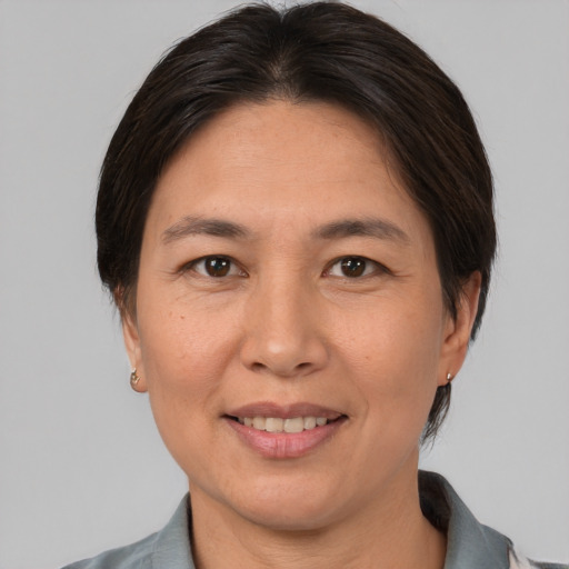 Joyful asian adult female with short  brown hair and brown eyes