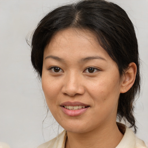 Joyful asian young-adult female with medium  brown hair and brown eyes