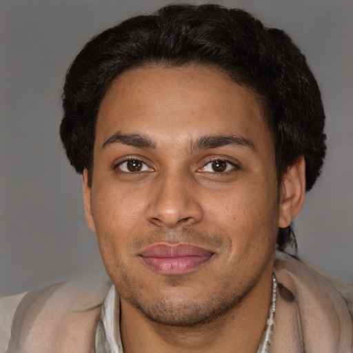 Joyful black adult male with short  brown hair and brown eyes