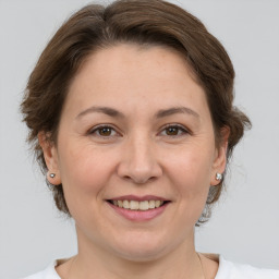 Joyful white adult female with medium  brown hair and brown eyes