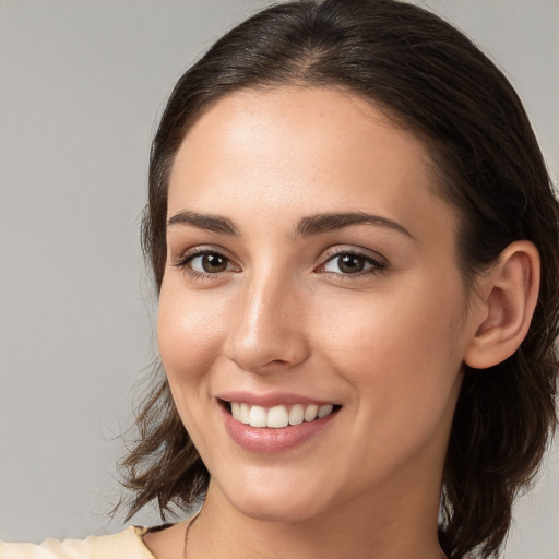 Joyful white young-adult female with medium  brown hair and brown eyes