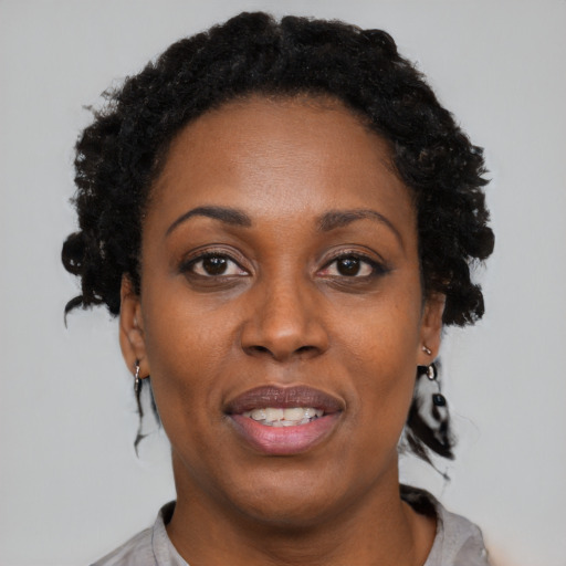 Joyful black adult female with short  black hair and brown eyes