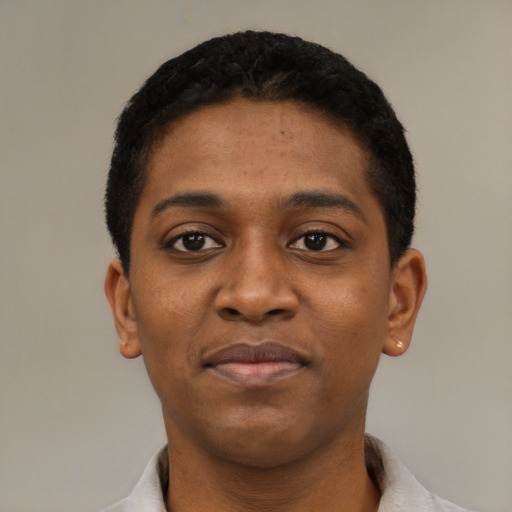 Joyful black young-adult male with short  black hair and brown eyes