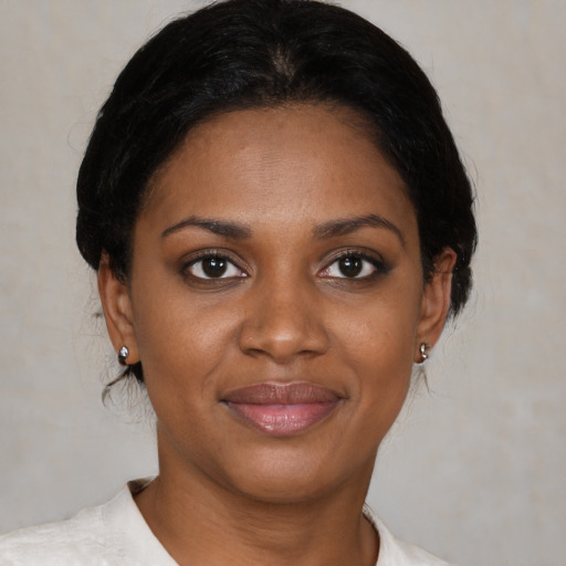 Joyful black young-adult female with medium  brown hair and brown eyes