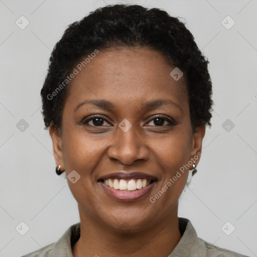 Joyful black young-adult female with short  brown hair and brown eyes