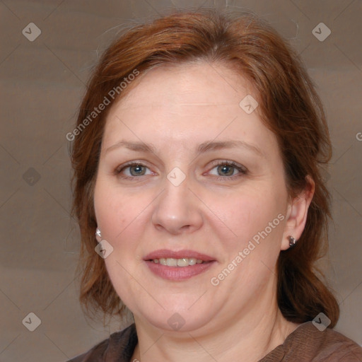 Joyful white adult female with medium  brown hair and blue eyes