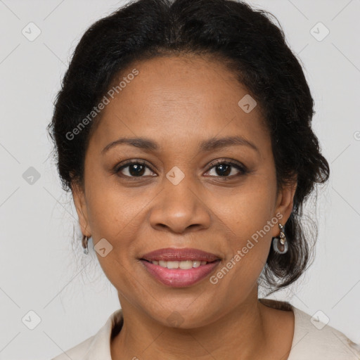 Joyful black adult female with medium  brown hair and brown eyes