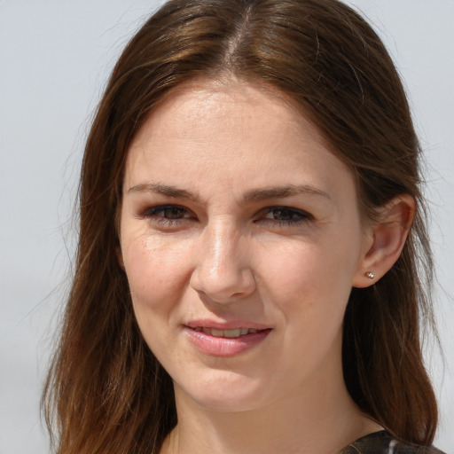 Joyful white young-adult female with long  brown hair and grey eyes