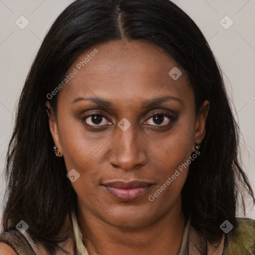 Joyful black adult female with long  brown hair and brown eyes