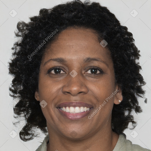 Joyful black adult female with medium  brown hair and brown eyes