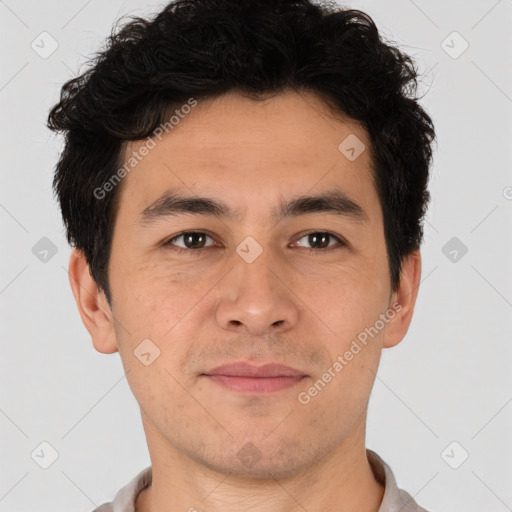 Joyful latino young-adult male with short  brown hair and brown eyes