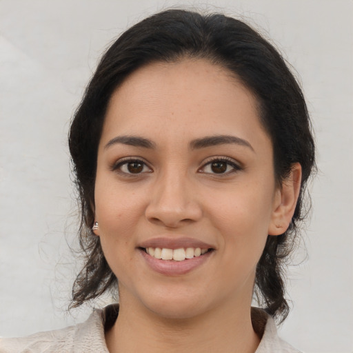 Joyful latino young-adult female with medium  brown hair and brown eyes