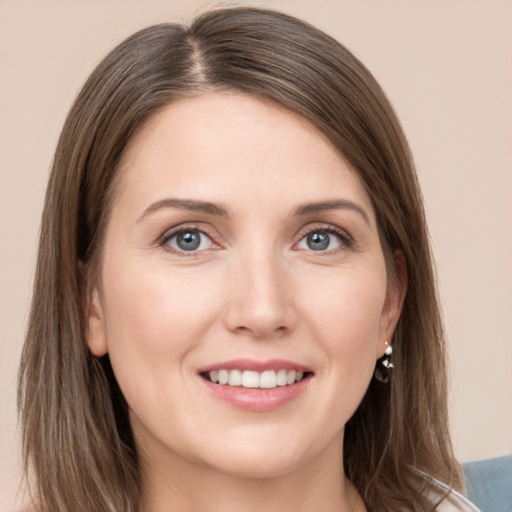 Joyful white young-adult female with medium  brown hair and grey eyes