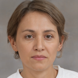 Joyful white adult female with medium  brown hair and brown eyes