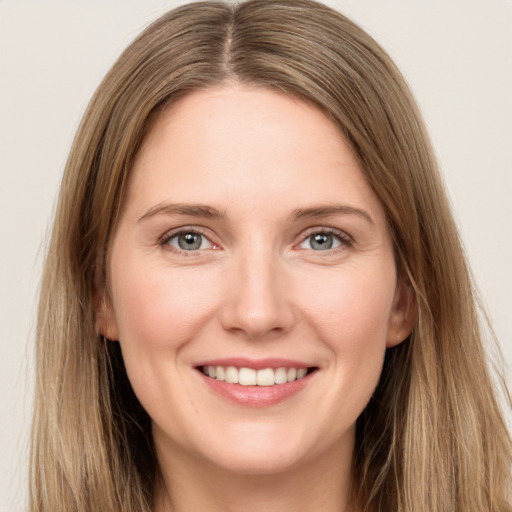 Joyful white young-adult female with long  brown hair and grey eyes