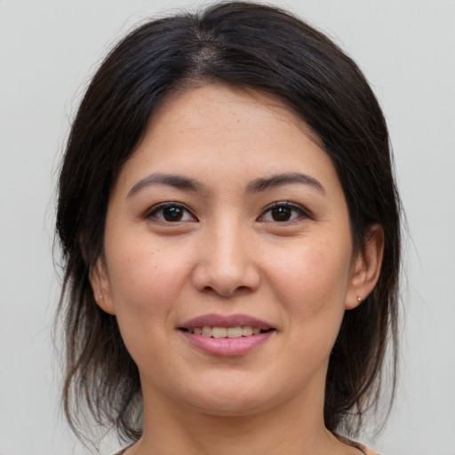 Joyful asian young-adult female with medium  brown hair and brown eyes