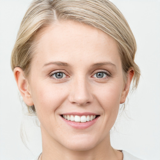 Joyful white young-adult female with medium  brown hair and blue eyes