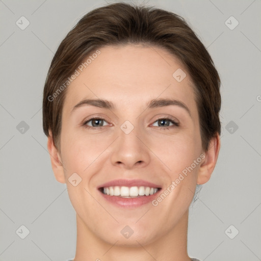 Joyful white young-adult female with short  brown hair and grey eyes