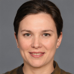 Joyful white adult female with short  brown hair and grey eyes