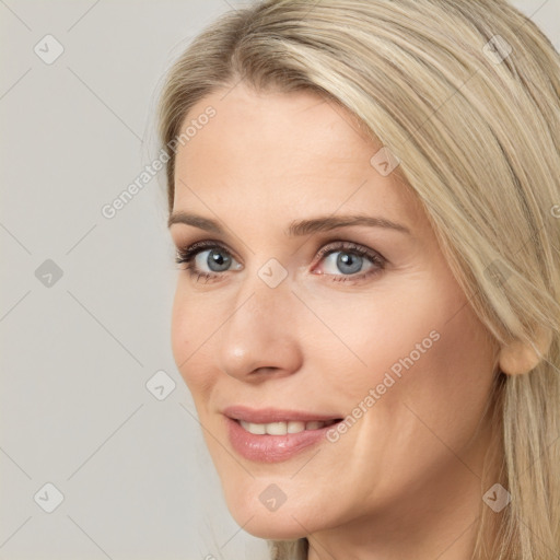 Joyful white young-adult female with long  brown hair and blue eyes