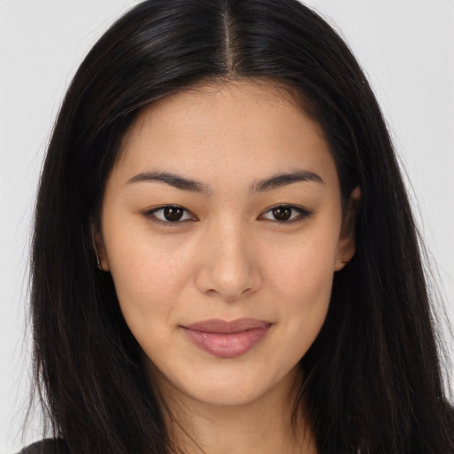 Joyful asian young-adult female with long  brown hair and brown eyes