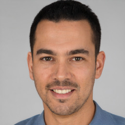 Joyful white young-adult male with short  black hair and brown eyes