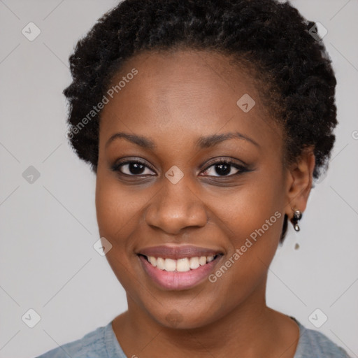 Joyful black young-adult female with short  brown hair and brown eyes